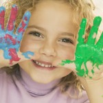 Be More Creative - shown by young girl with paint all over her hands