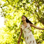 meditation for relaxation shown by happy woman standing with arms stretched out